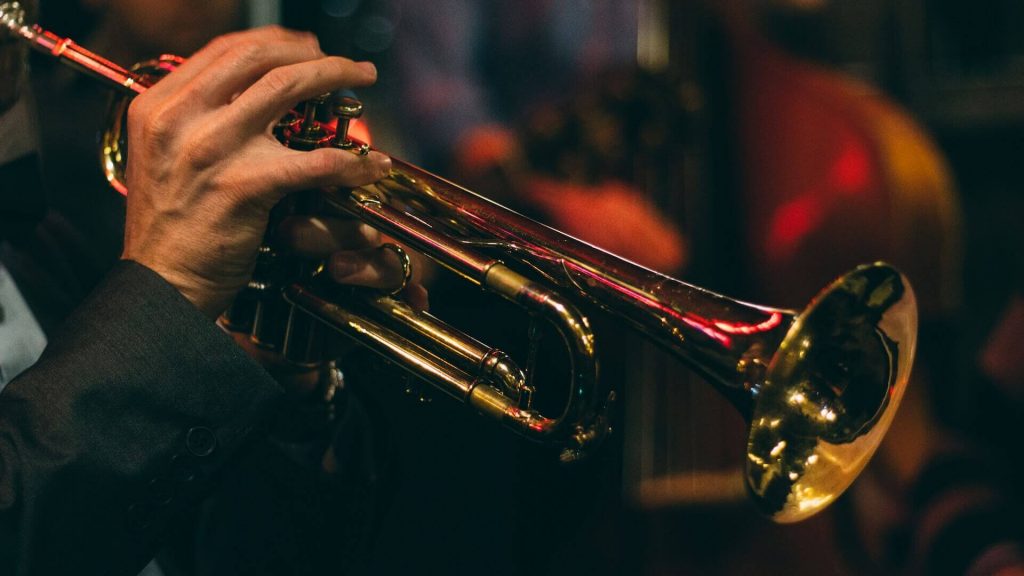 A musician passionately playing a trumpet, creating melodious tunes.